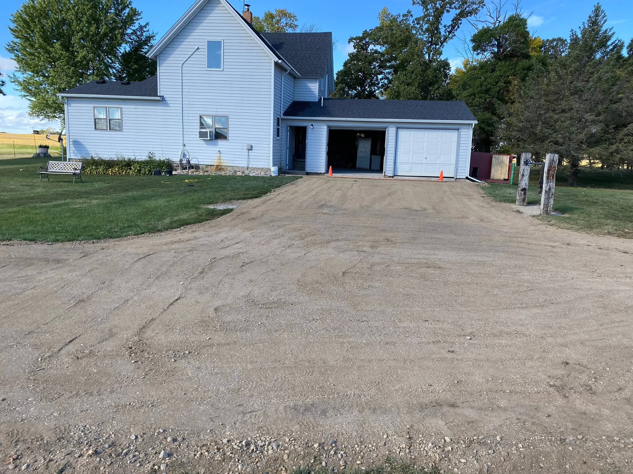 Graded gravel approach to a garage.
