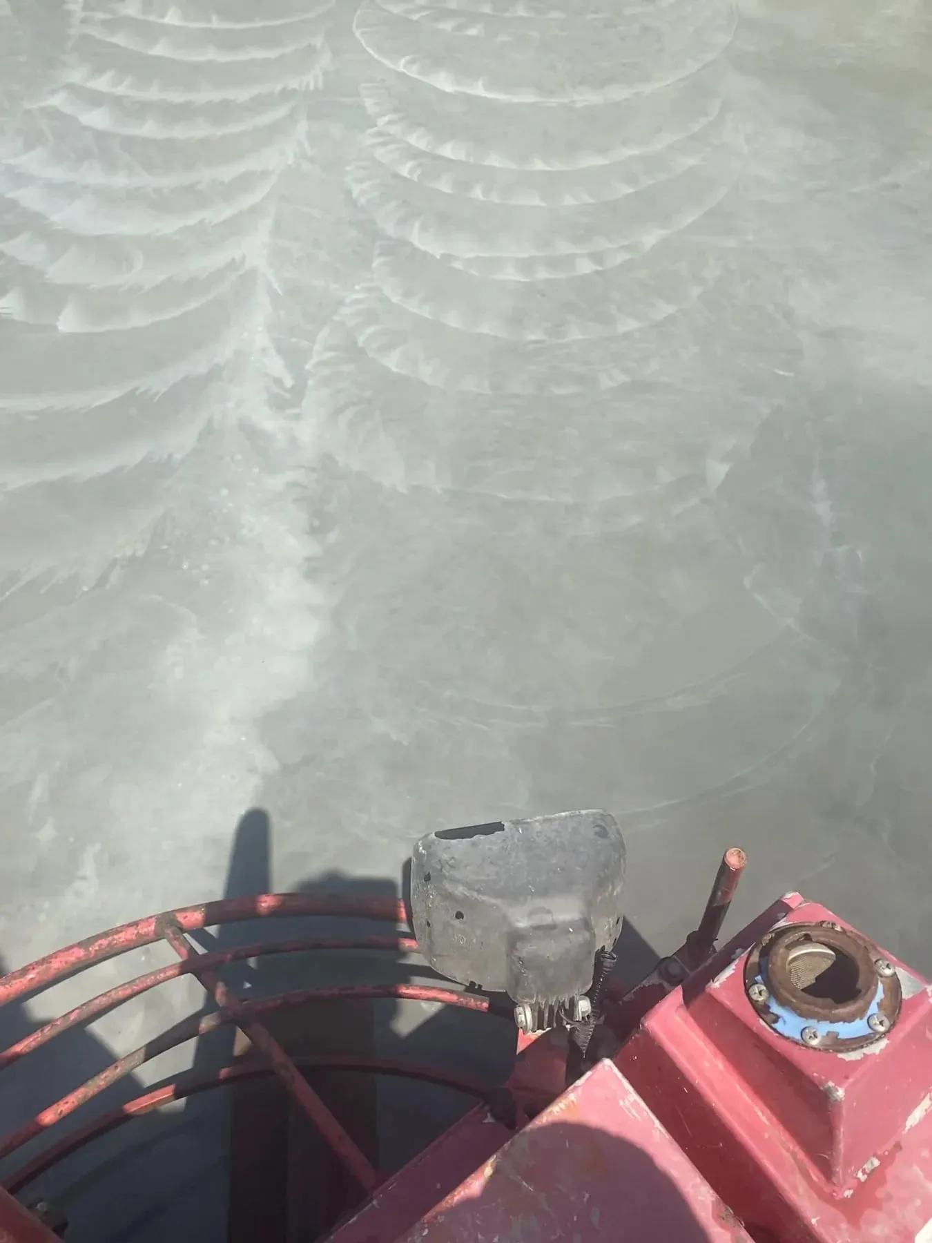Power-trowel operator point of view on a large outdoor concrete slab, June 2021.