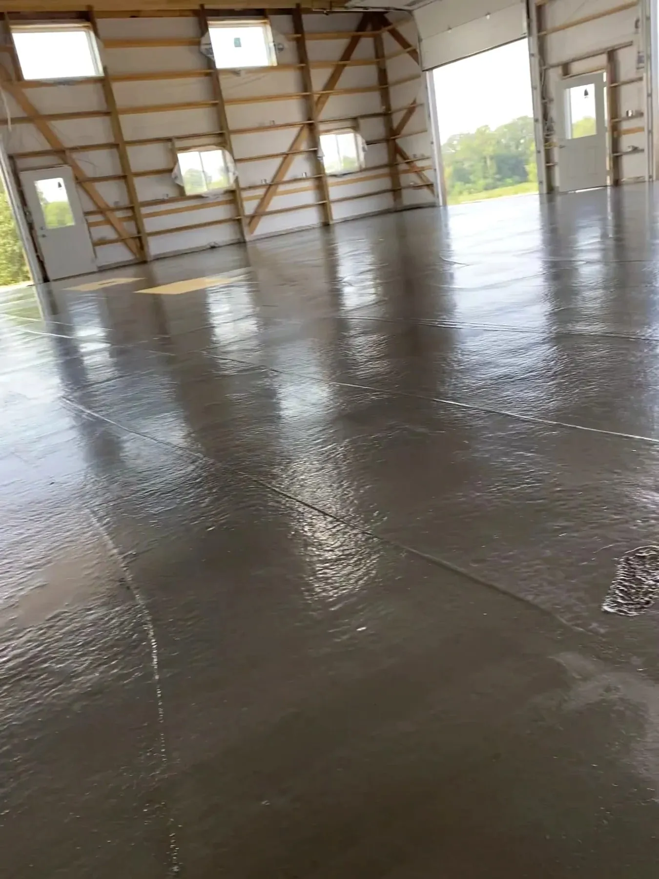 Interior pole-shed concrete floor during finishing, August 2021.