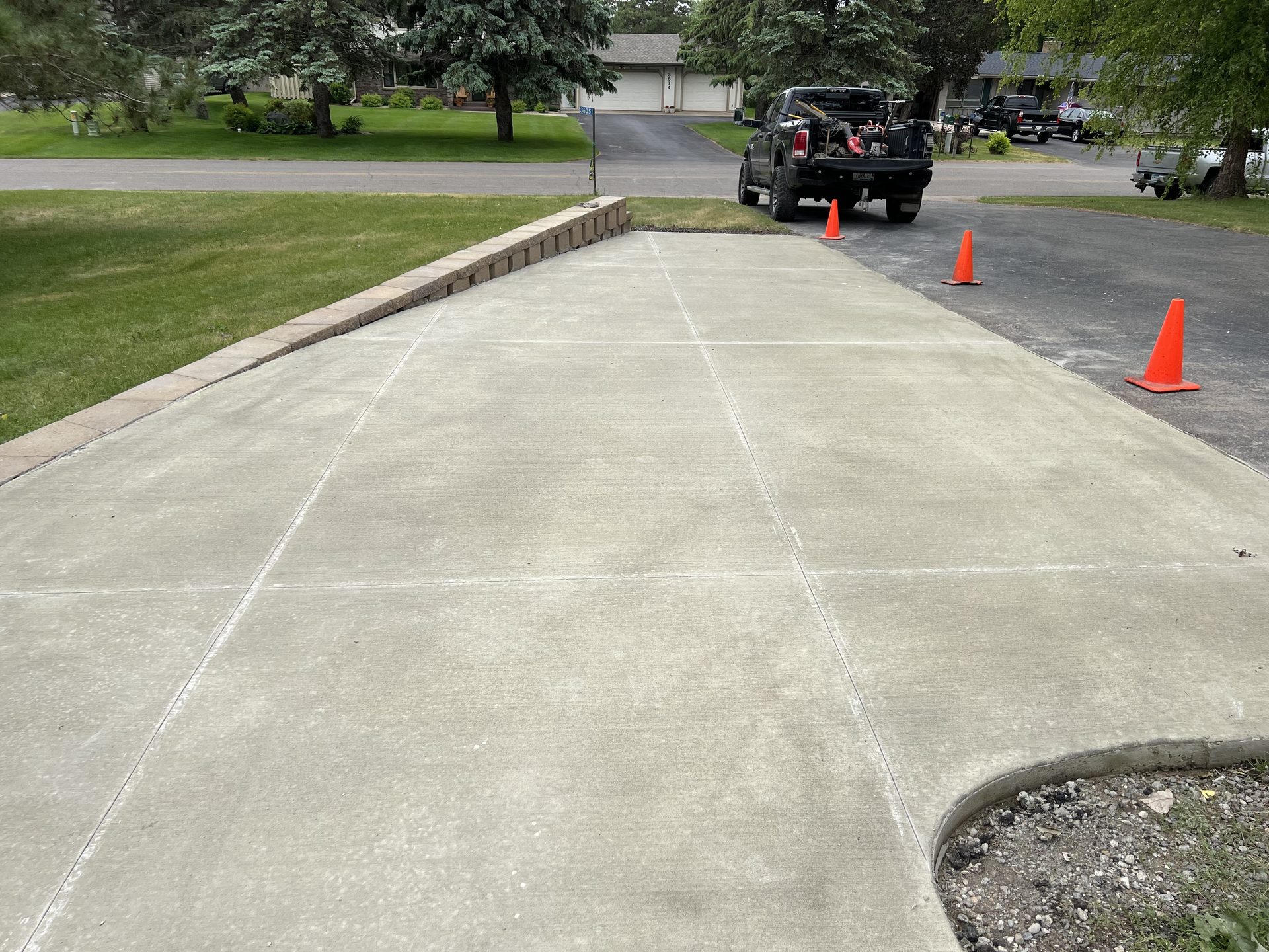 Newly finished concrete driveway with clean expansion joints and decorative border edging.