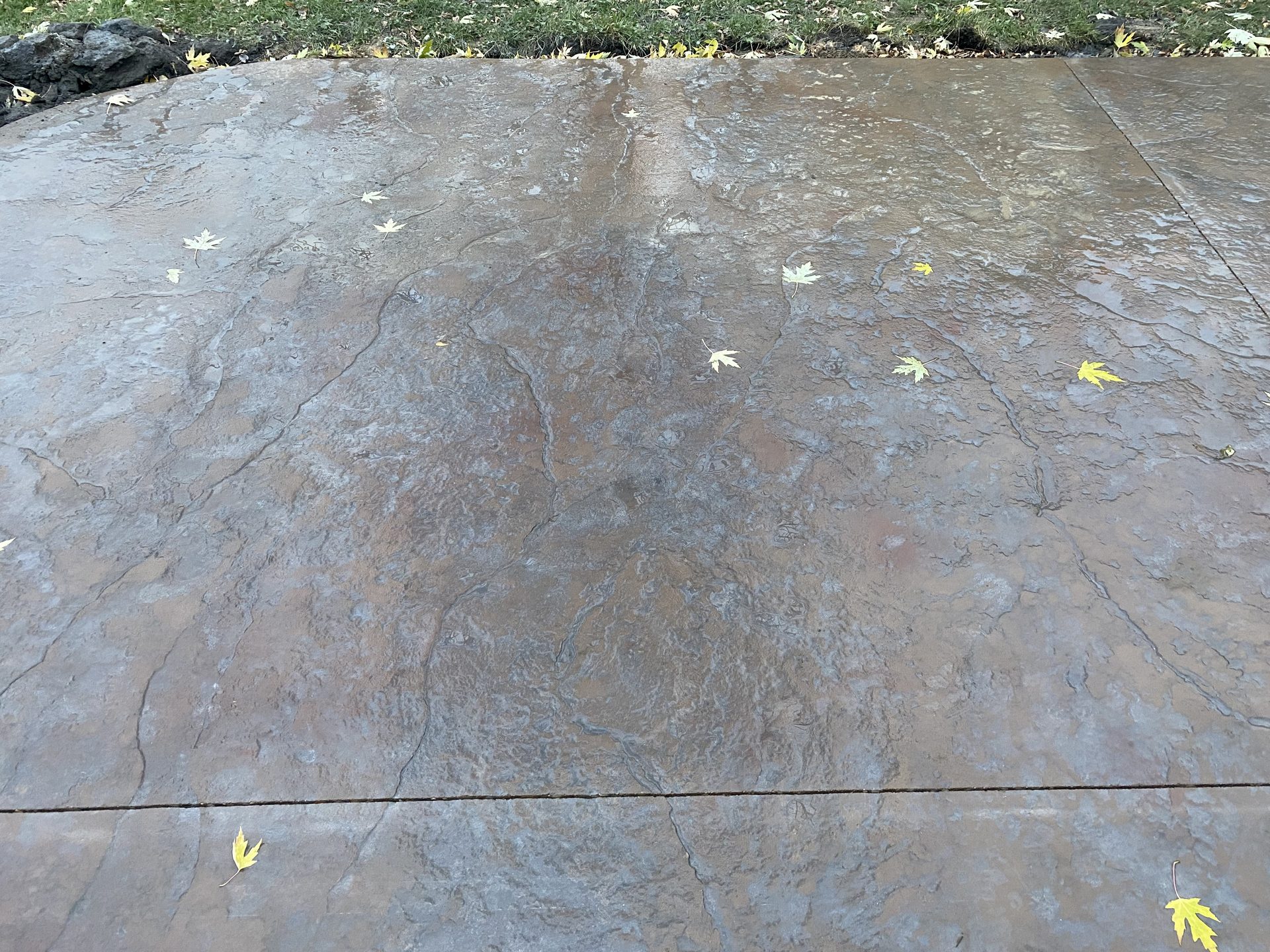 Finished concrete patio or patio surface with smooth troweled finish and control joint visible.